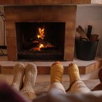 Family's socked feet in front of fireplace cared for by Manahawkin chimney service